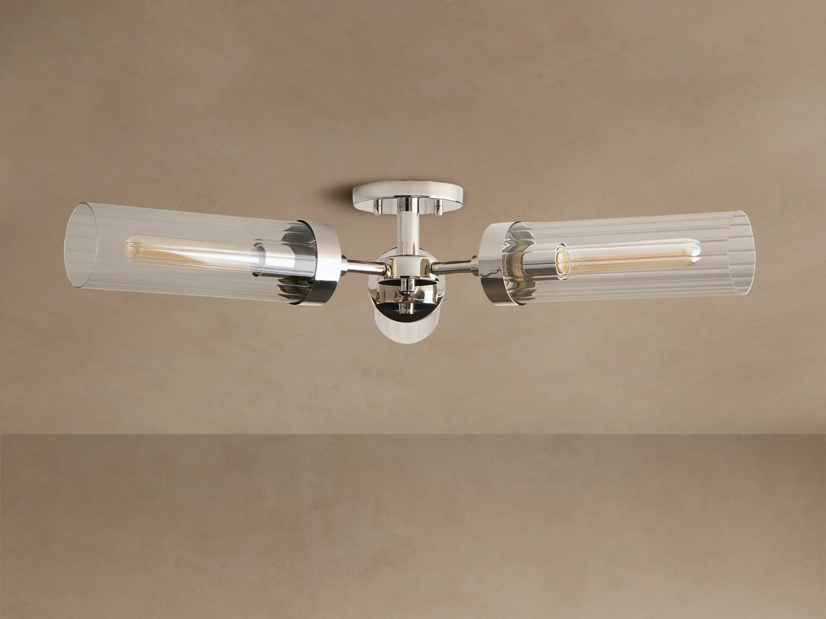 Andreas Flush Mount, polished nickel, with two horizontal clear ribbed glass shades, showcasing glowing filament bulbs.