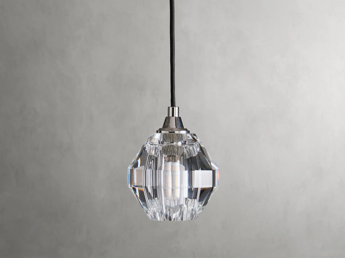 Amoroso Pendant with faceted crystal shade hanging from a black cord, showcasing a dimmable LED bulb inside.