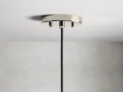 Amoroso Pendant featuring a crystal-cut shade with visible LED bulb, nickel finish cap, and black cord against a gray background.