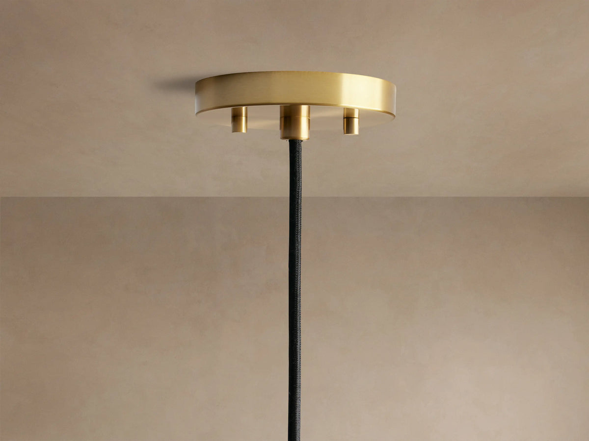 Organic 8" Pendant close-up: seeded clear glass shade with an organic shape, brass-toned fitting, and glowing filament bulb.