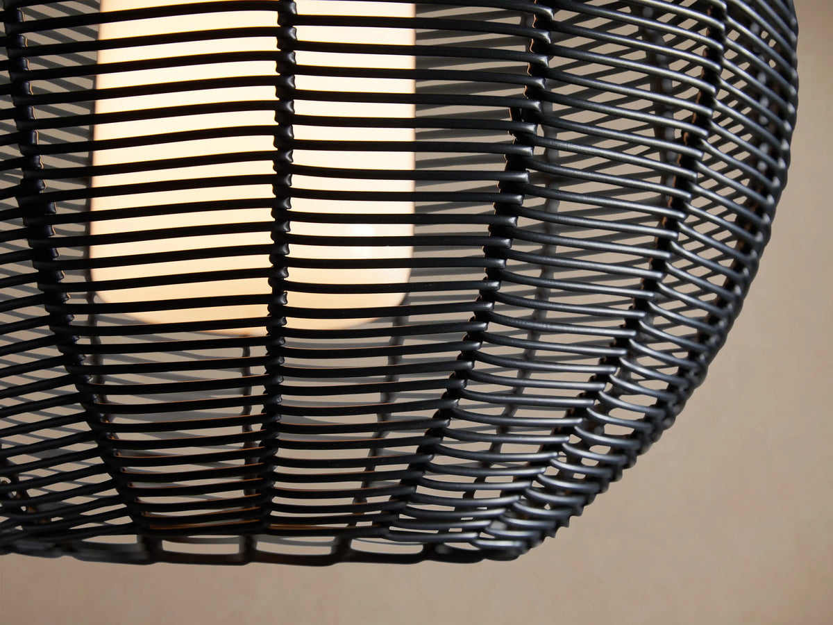 Cohen Globe Outdoor Pendant: Black woven wicker globe shade with a white inner glass diffuser, hanging from a black pole.