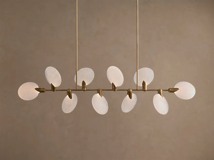 Lyla Linear Chandelier, 8 glowing frosted glass oval shades on a horizontal antique brass bar, suspended from above.