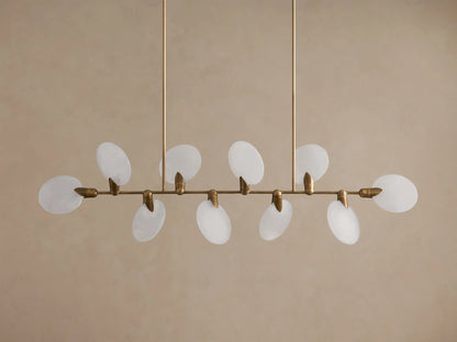 Lyla Linear Chandelier, 8 glowing frosted glass oval shades on a horizontal antique brass bar, suspended from above.