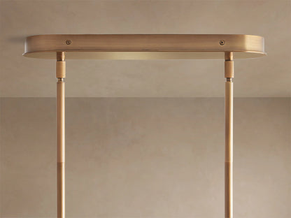 Close-up of Lyla Linear Chandelier with milky white, irregularly shaped hand-blown glass shades on a plated brass frame.