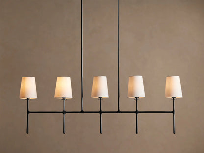 Rhodes Linear Chandelier with 5 tapered light linen shades on a dark metal horizontal bar, hanging from two rods.