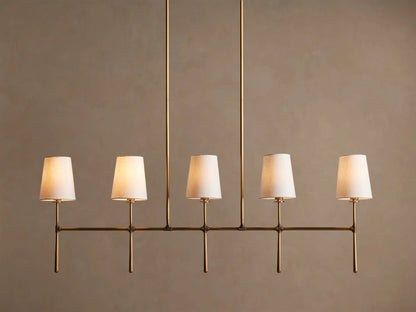 Rhodes Linear Chandelier, burnished brass finish, 5 lights with tapered off-white linen shades.