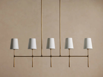 Rhodes Linear Chandelier, burnished brass finish, 5 lights with tapered off-white linen shades.