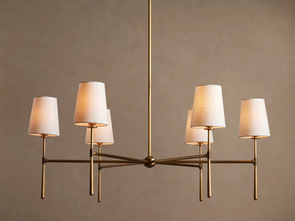 Rhodes Round Chandelier, 6-light, with burnished brass frame & 6 glowing tapered linen shades.
