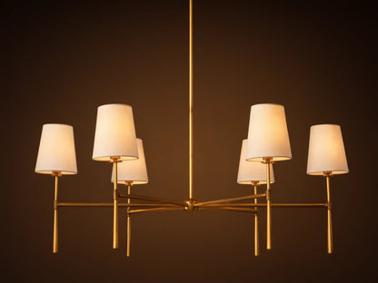 Rhodes Round Chandelier, 6-light, with burnished brass frame & 6 glowing tapered linen shades.