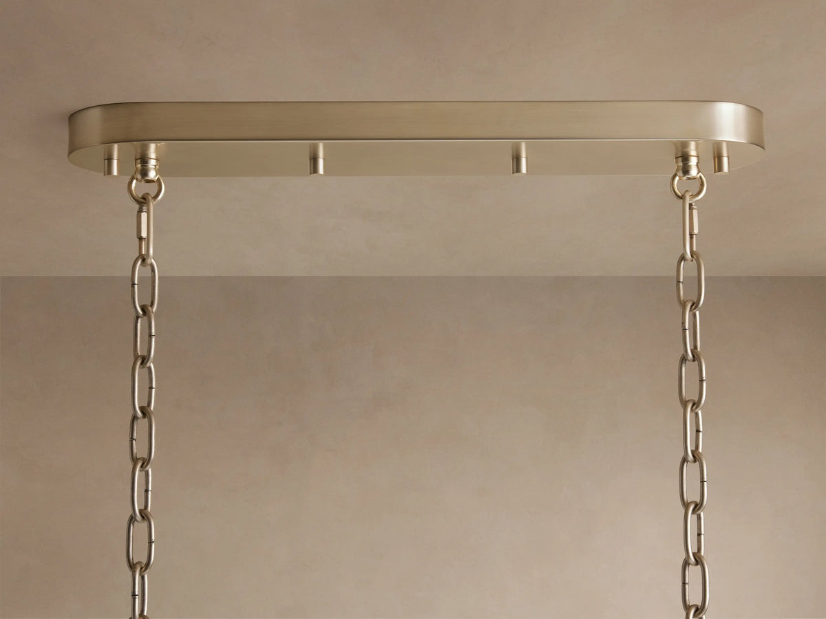 Neve Linear Chandelier's champagne-finished aluminum canopy mounted to a light ceiling, with two elegant hanging chains.