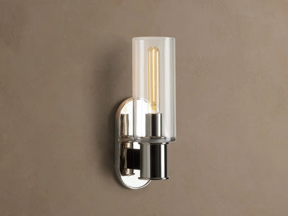 Harlin Sconce with polished nickel finish and clear glass cloche, mounted vertically on a wall, showing an Edison bulb.