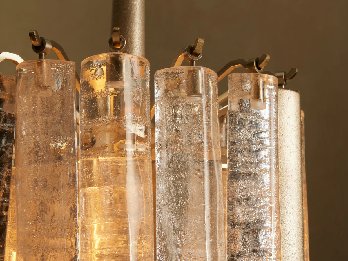 Neve Pendant: Champagne-finished aluminum pendant with clear, textured cast glass elements arranged in cascading tiers.
