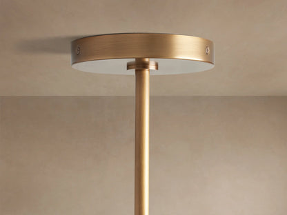 Close-up of Mandoza Chandelier: numerous clear, hand-blown glass globes with bubbly texture, warm light, burnished brass frame.