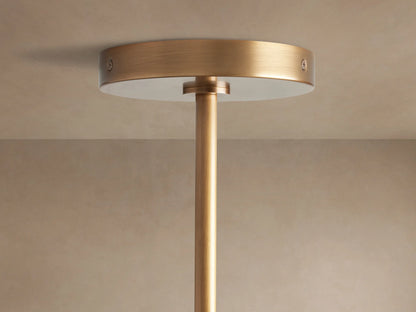 Mandoza Chandelier: close-up of clear, hand-blown bubbled glass globes, illuminated with warm light, mounted on a burnished brass frame.