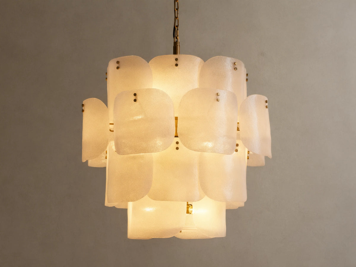 Blaire Round Chandelier. Multi-tiered, round chandelier with textured, pearlescent white molten glass panels glowing softly. Brass chain.