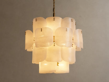 Blaire Round Chandelier. Multi-tiered, round chandelier with textured, pearlescent white molten glass panels glowing softly. Brass chain.