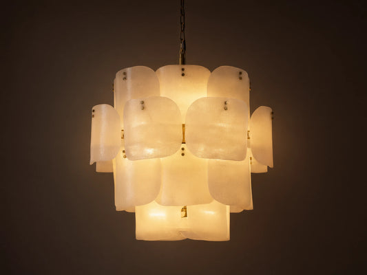 Blaire Round Chandelier. Multi-tiered, round chandelier with textured, pearlescent white molten glass panels glowing softly. Brass chain.