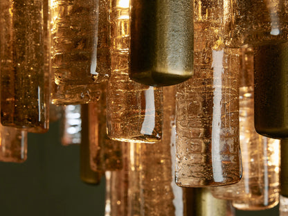 Neve Flush Mount, a tiered light fixture with champagne-finished aluminum rods and textured clear/bronze cast glass elements.