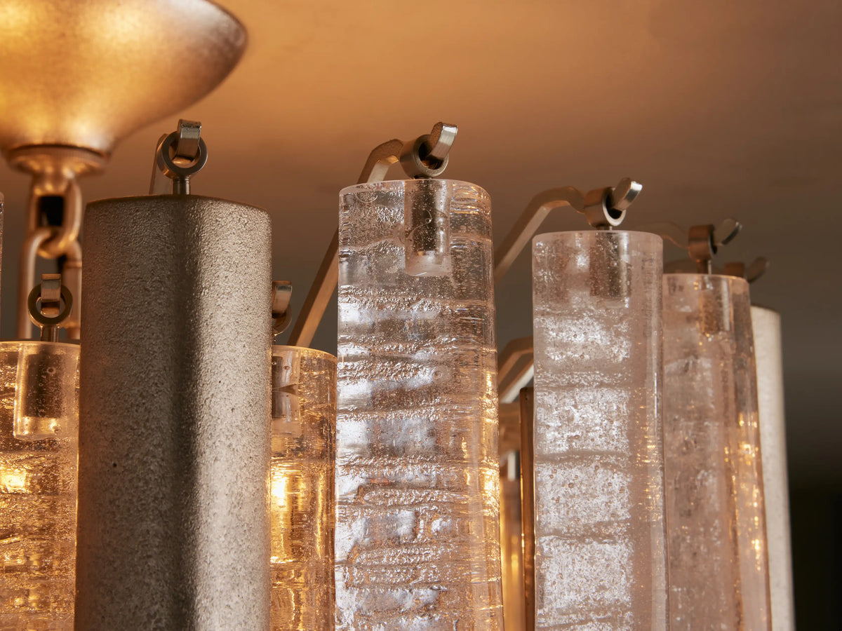 Neve Flush Mount light fixture with tiered clear textured glass rods and champagne-finished aluminum cylinders, mounted on a ceiling.
