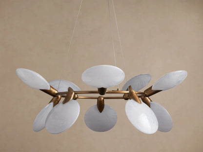 Lyla Round Chandelier with a circular brass-plated frame, featuring 10 glowing, oval hand-blown white glass shades, hanging.