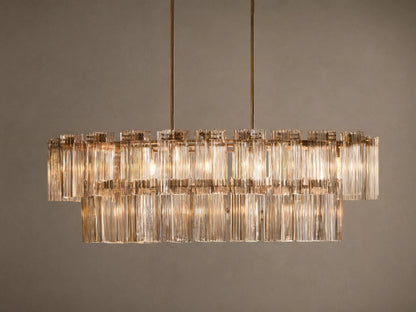 Delsie Oval Tiered Chandelier, burnished brass finish, two tiers of illuminated fluted glass rods on a simple background.