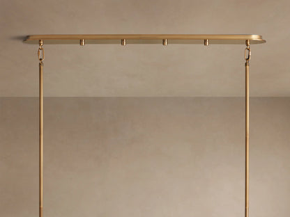 Delsie Oval Tiered Chandelier, burnished brass finish, two tiers of illuminated fluted glass rods on a simple background.