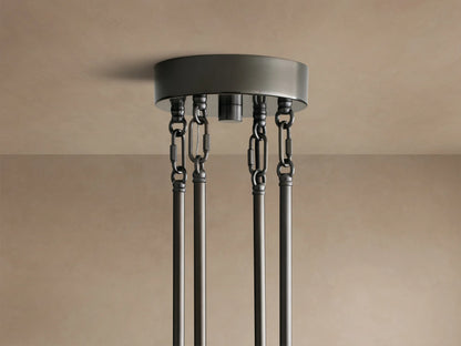Close-up of Delsie Round Chandelier showing clear fluted glass panels and dark metal frame reflecting warm light.