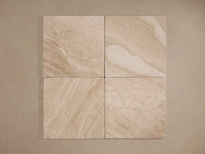 Four light beige square natural stone tiles with subtle veining, showcasing material for the Christie Floor Lamp's base.
