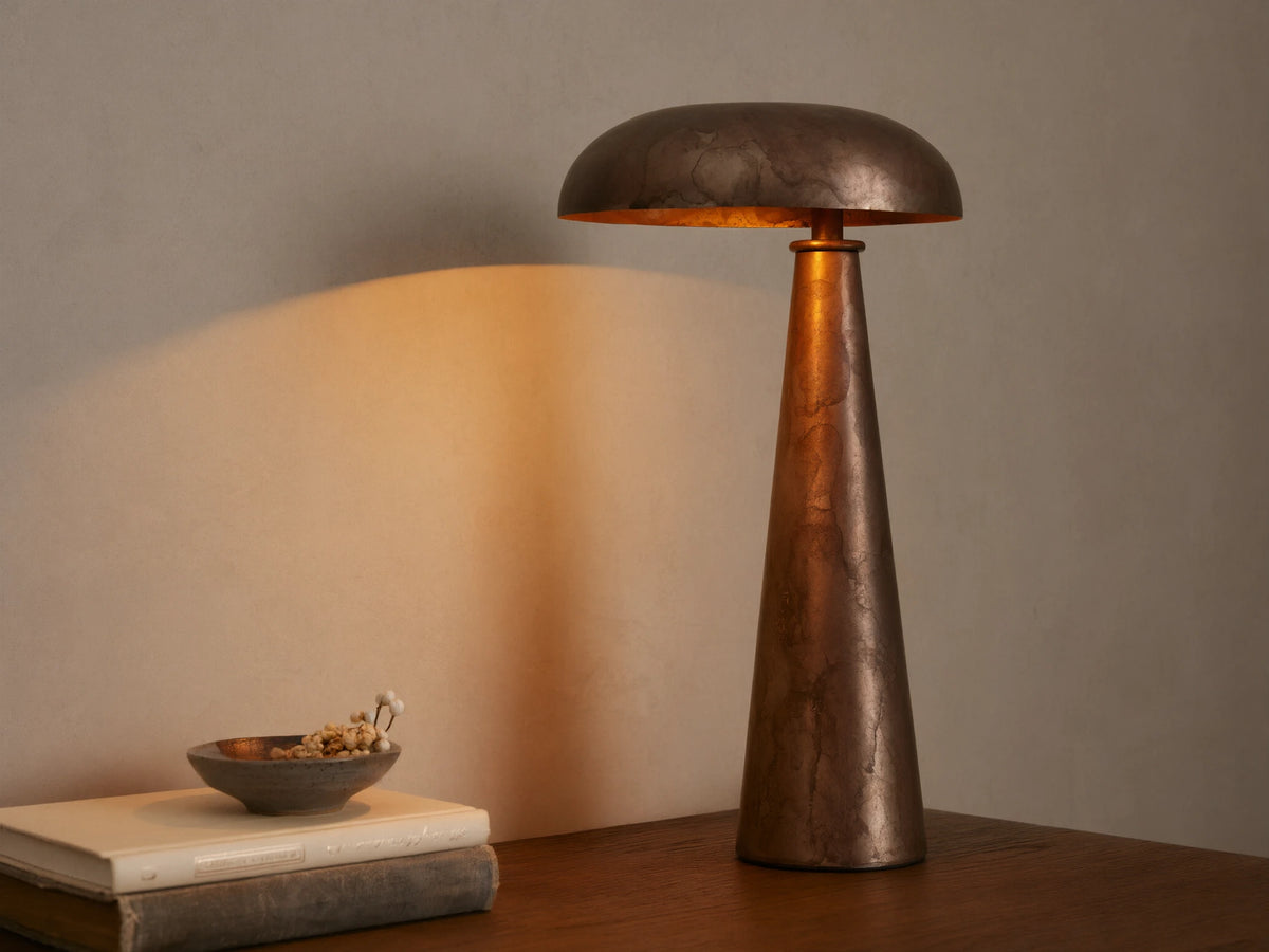 Chantou Table Lamp, antiqued brown, copper & pewter finish, mushroom shade & conical base, casting warm light.