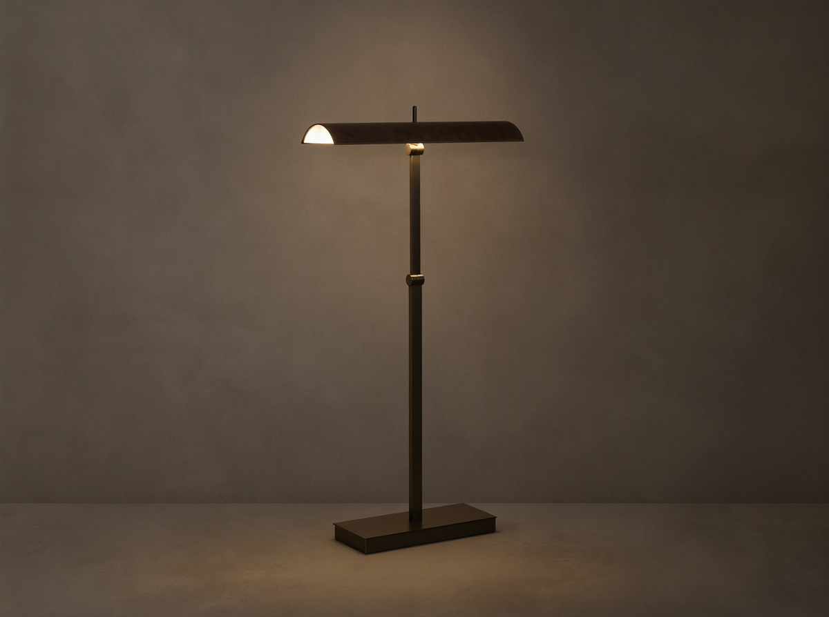 Abel Leather Floor Lamp: dark bronze finish, horizontal leather shade emitting warm LED light, stands on a wood floor.