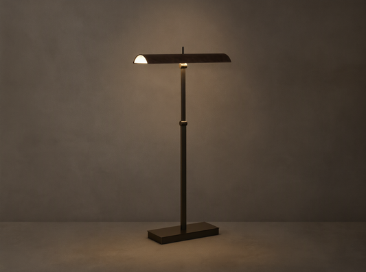 Abel Leather Floor Lamp: dark bronze finish, horizontal leather shade emitting warm LED light, stands on a wood floor.