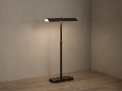 Abel Leather Floor Lamp: dark bronze finish, horizontal leather shade emitting warm LED light, stands on a wood floor.