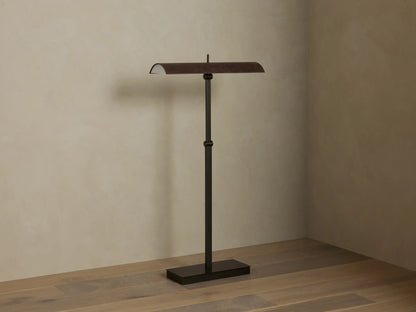 Abel Leather Floor Lamp: dark bronze finish, horizontal leather shade emitting warm LED light, stands on a wood floor.