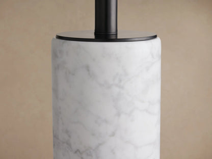 Brixton Table Lamp: cylindrical white marble base, black metal stem, and light beige fabric drum shade on a wooden table.