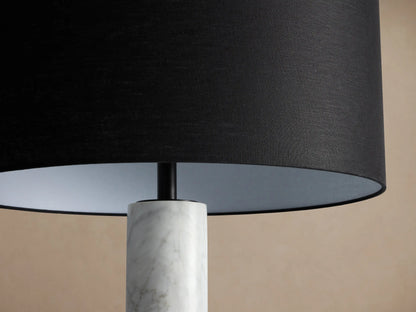 Brixton Floor Lamp: Tall, elegant, with white marble column, black drum shade, and round black base on a wood floor.