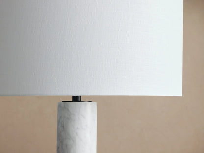 Brixton Floor Lamp with white cylindrical shade, white marble column, and dark round base on wooden floor against neutral wall.