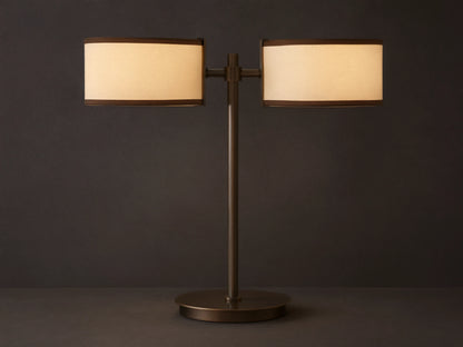 Daphne 2-Light Table Lamp with bronze-finished steel base and two cream shades with brown trim on a wooden surface.