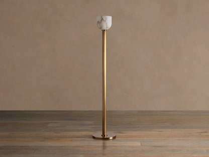 Illuminated Ansley Floor Lamp with a slender, antique brass stem & base, topped by a glowing, veined alabaster bowl shade.