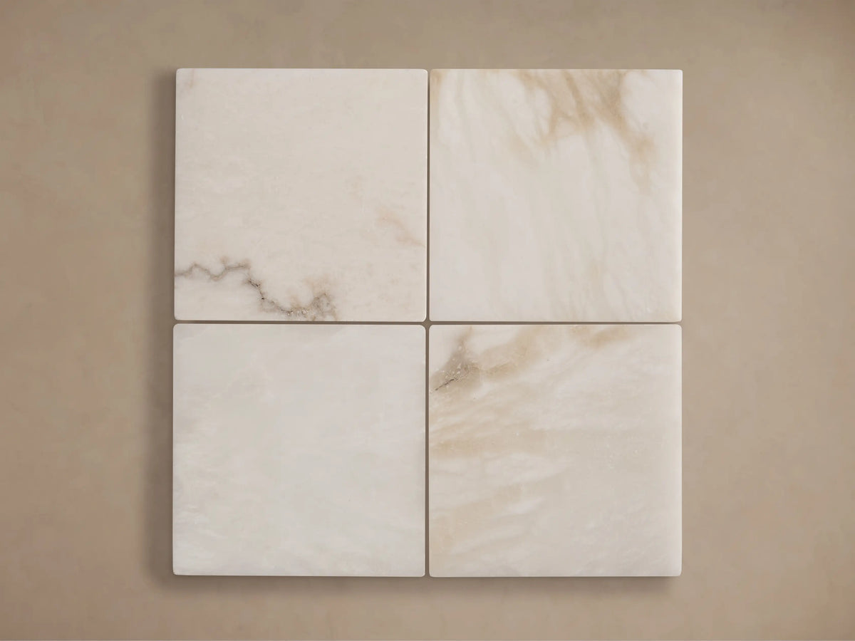 Close-up of Ansley Floor Lamp's translucent white alabaster stone shade with natural brown veining, on a warm brushed brass column.