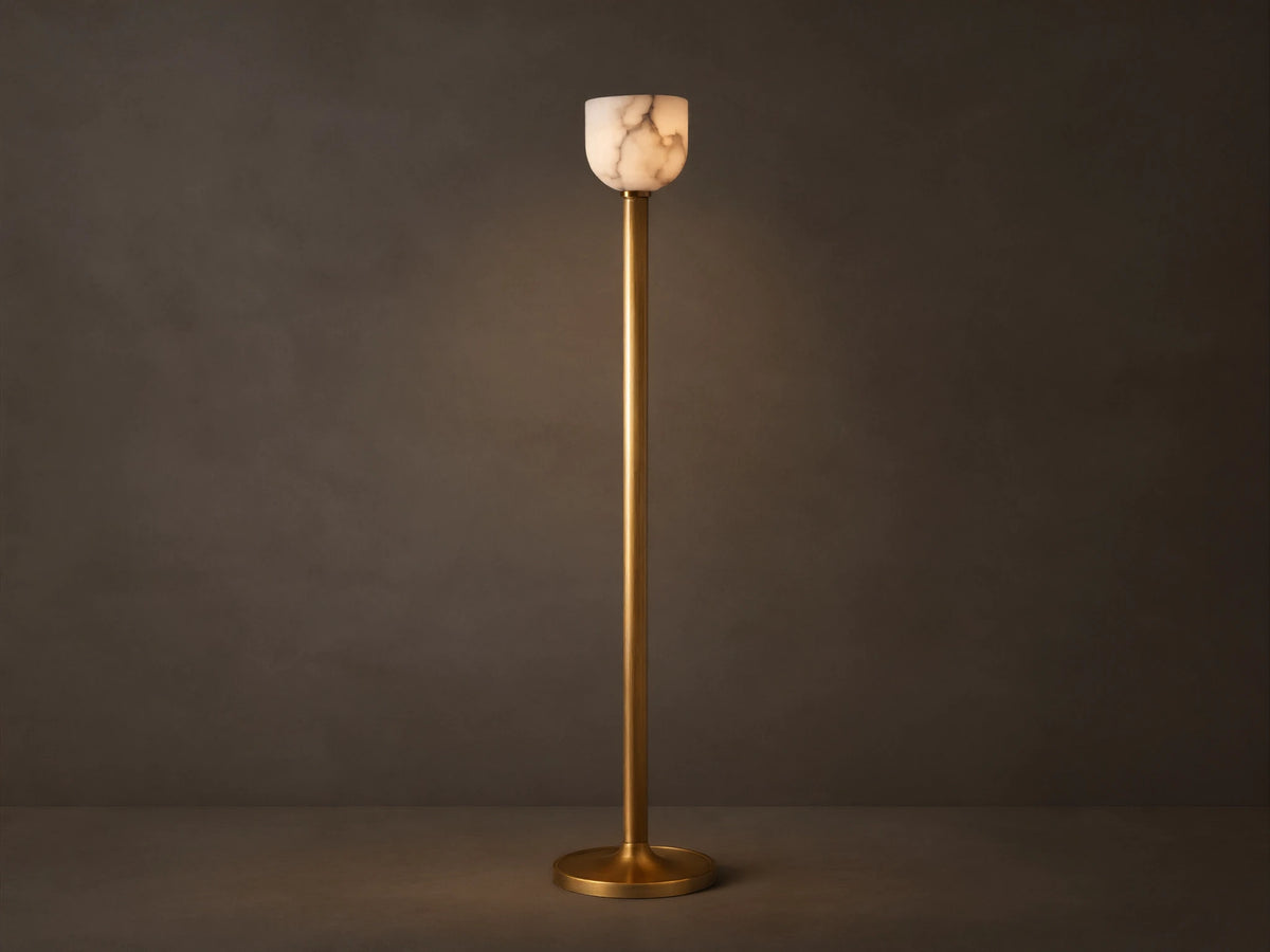 Illuminated Ansley Floor Lamp with a slender, antique brass stem & base, topped by a glowing, veined alabaster bowl shade.