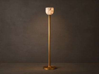 Illuminated Ansley Floor Lamp with a slender, antique brass stem & base, topped by a glowing, veined alabaster bowl shade.