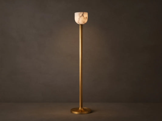 Illuminated Ansley Floor Lamp with a slender, antique brass stem & base, topped by a glowing, veined alabaster bowl shade.