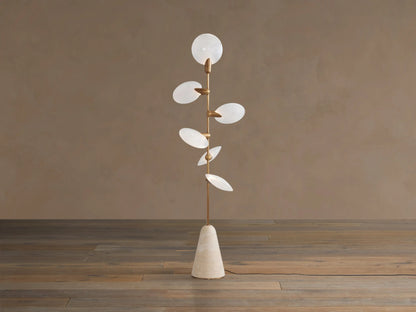 Lyla Floor Lamp: conical travertine base, golden stem with six glowing leaf-shaped white glass diffusers spirally.
