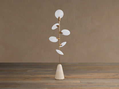 Lyla Floor Lamp: conical travertine base, golden stem with six glowing leaf-shaped white glass diffusers spirally.