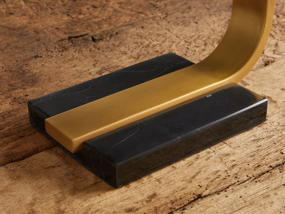 Karson Task Table Lamp, modern U-shaped design with brass finish and black marble base, on a rustic wood table.