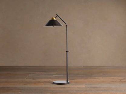 Close-up of Marquee Bronze Task Floor Lamp. Conical dark bronze shade with a brass top accent, angled on a dark arm.