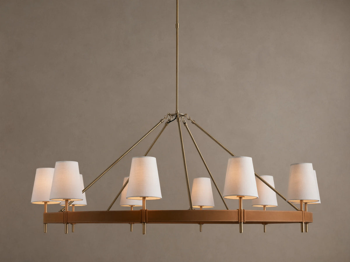 Hastings Round Chandelier, antiqued brass frame with brown leather, and 8 glowing white linen shades.