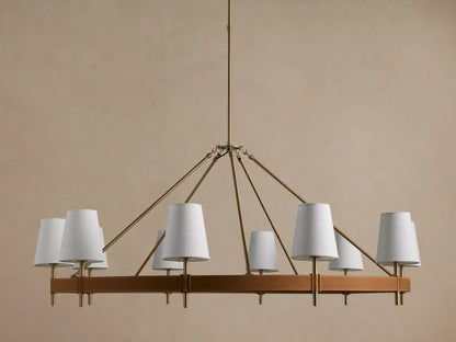 Hastings Round Chandelier, antiqued brass frame with brown leather, and 8 glowing white linen shades.