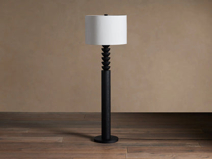 Black Lathe Floor Lamp with a cylindrical black oak base, stacked carved black wood details, and an off-white linen drum shade.