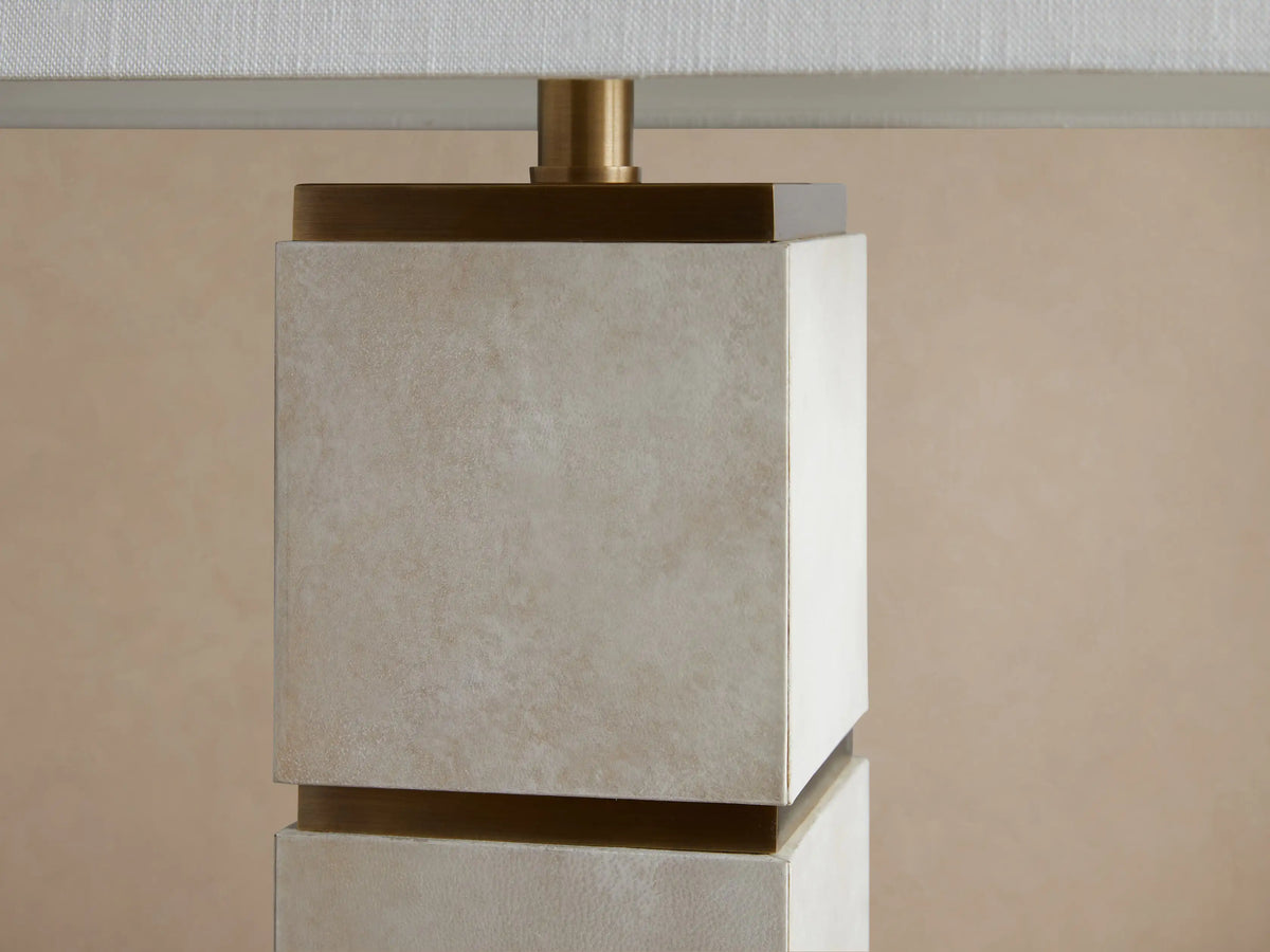 Micha Tall Table Lamp, front view. White rectangular linen shade over a tall, light parchment leather base with brass accents.